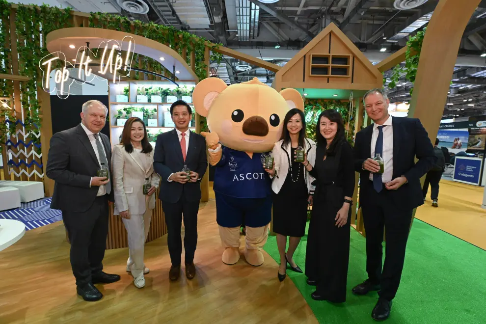 Mr Alvin Tan, Minister of State, Ministry of Trade and Industry and Ministry of Culture, Community and Youth (third from left), enjoying a bottle of healthy green juice crafted to represent the Somerset brand at Ascott's booth at ITB Asia 2024. He was accompanied by (from left to right) Mr David Ruetz, Senior VP, Messe Berlin; Ms Melissa Ow, Chief Executive, Singapore Statutory Board; Ms Beh Siew Kim, Chief Financial & Sustainability Officer for CLI Lodging and MD of Japan and Korea, Ascott; Ms Tan Bee Leng, Chief Commercial Officer for Ascott; and Mr Mario Tobias, CEO of Messe Berlin, with a special appearance by Cubby, Ascott's beloved mascot.