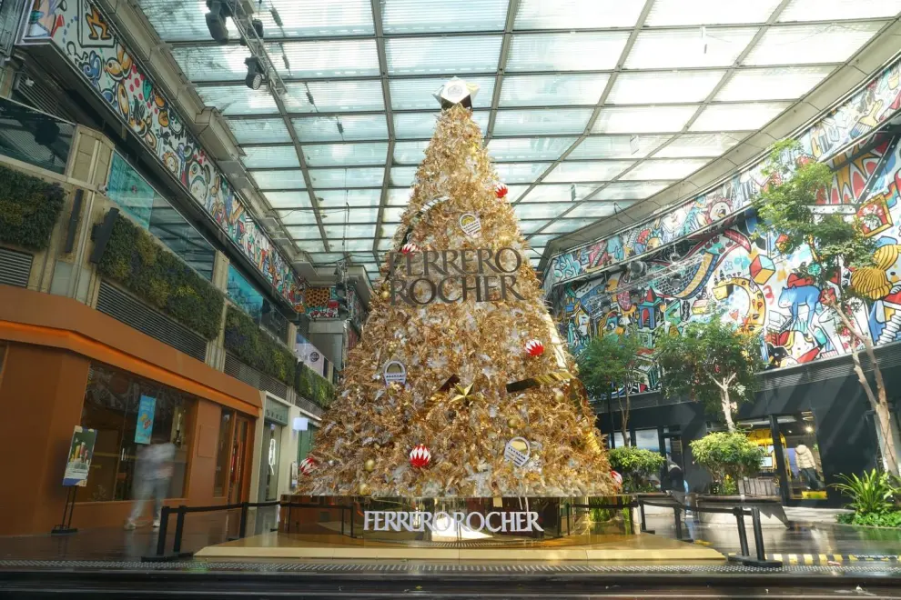 Anchored in the center of the Ferrero Rocher's Golden Christmas Garden stands the towering Christmas tree over 7 meters tall