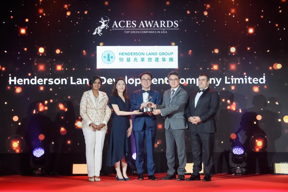 Johnny Yu, Head of Sustainability and Advisor to the Chairman, Henderson Land Development Company Limited (Centre), proudly accepts the ACES Awards 2024 Top Green Companies in Asia accolade on stage. Standing alongside him are Edward Chan, Deputy General Manager (Right Centre), and Hazel Cheng, Project Manager - Sustainability (Left Centre), representing the company's unwavering commitment to sustainability. The award is presented by Dr Shanggari Balakrishnan, President of the ACES Awards (Far Left), and Luis Bueno Nieto, Advisor to the ACES Council (Far Right), marking a moment of triumph and recognition for Henderson Land Development's leadership in driving green innovation across Asia.