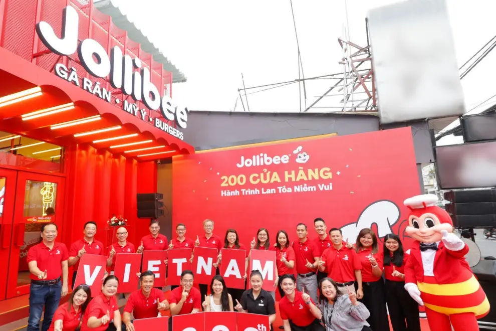 Jollibee Group celebrates the opening of its 200th Jollibee Store in Vietnam, solidifying its position as one of the top restaurant chains in the country. The ceremony was led by Jollibee Group executives, including Jollibee Group Global Chief Executive Officer Ernesto Tanmantiong (2nd row, 5th from left); Jollibee Group Philippines CEO and Jollibee Global Head Joseph Tanbuntiong (2nd row, 6th from left); Jollibee Group Global Chief Business Support Officer William Tan Untiong (2nd row, 3rd from left); Jollibee Group Chief Financial and Risk Officer Richard Shin (2nd row, 2nd from left); Jollibee EMEAA President Dennis Flores (2nd row, 4th from left); Jollibee Vietnam Managing Director Lam Hong Nguyen (1st row, 3rd from left).