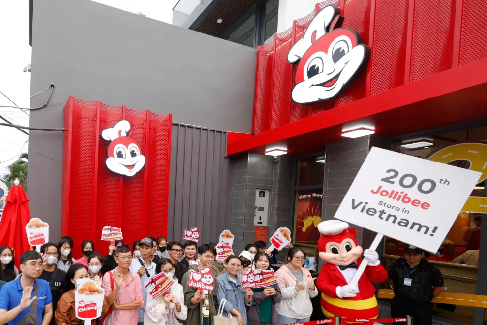 Vietnamese customers eagerly await as Jollibee Vietnam celebrates its 200th store on December 12, 2024 at 704 Hau Giang Street, Ward 12, District 6, Ho Chi Minh City.