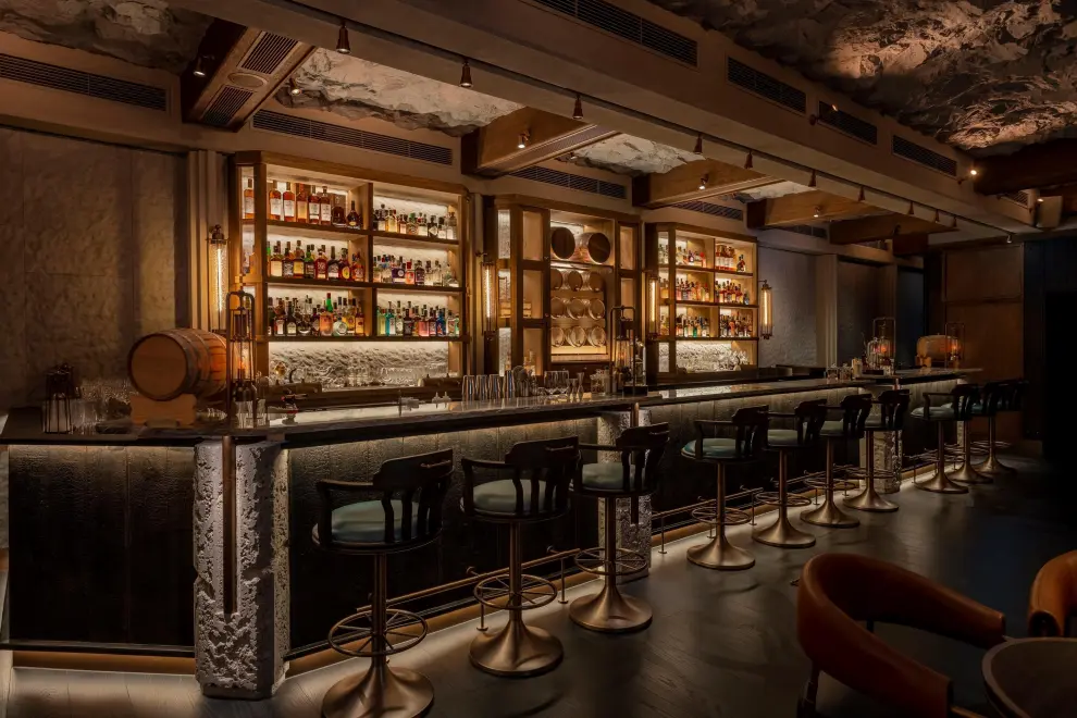 The interior design of Long Bar is inspired by the coastal caves of Macau where the gin was distilled and stored, as well as the voyages of the legendary Portuguese merchant ship Madre de Deus and has been honored with the "Best Hotel Bar Design" award at the 2024 VOGUE LIVING DESIGN AWARDS