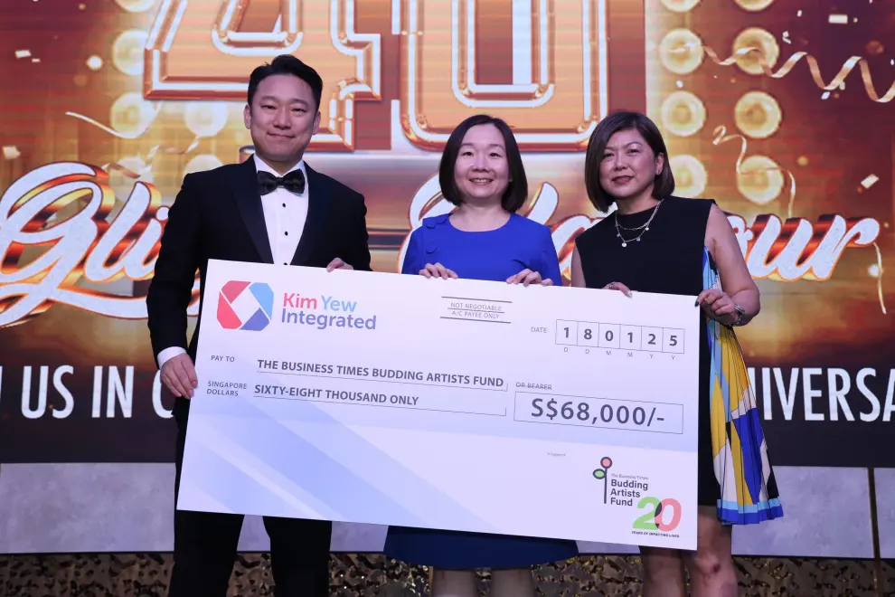 Mr Patrick Tan, Managing Director of Kim Yew Integrated, presents a cheque during Kim Yew Integrated's 40th anniversary dinner to Ms Chen Hui Fen, Editor of The Business Times and Board Member of TRCL, and Ms Elaine Tan, Head of Partnership Development at TRCL.