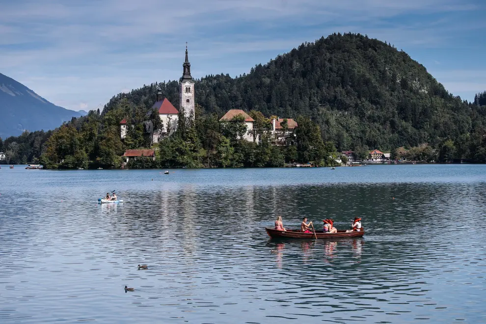Boats on Lake Bled with the island in the background. Photo: Anže Malovrh/STA