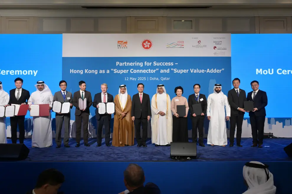 HKSAR's Chief Executive John Lee (seventh right) witnesses agreements signed between government department, enterprises, and institutions from Hong Kong, Mainland China and Qatar.